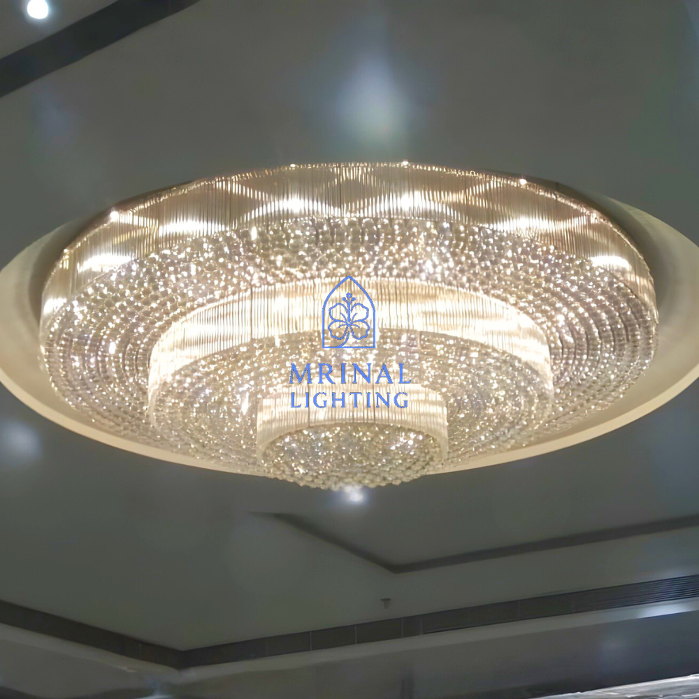 grand round crystal chandelier installed in luxury banquet hall ceiling