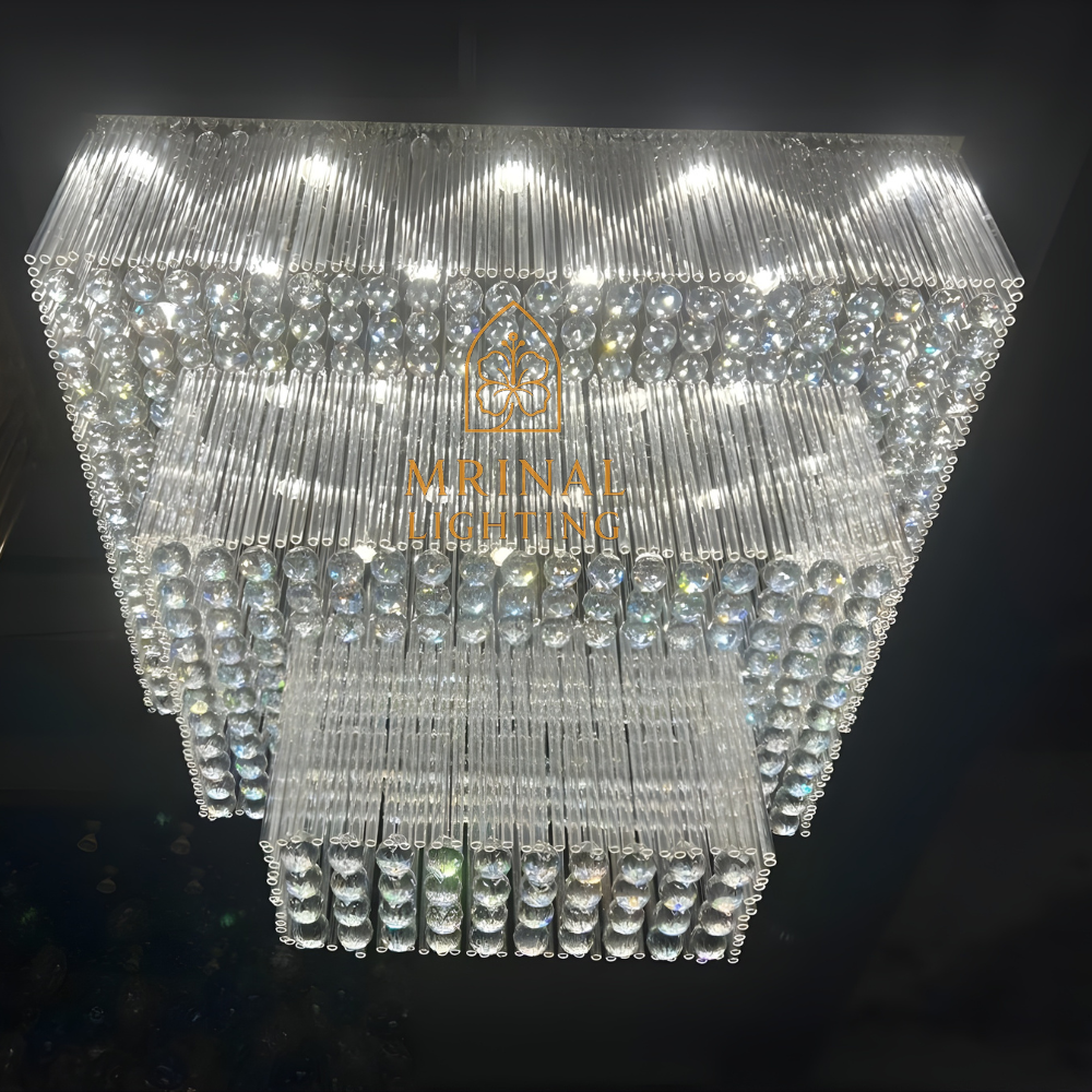 Modern rectangular crystal chandelier installed in hotel lobby entrance area